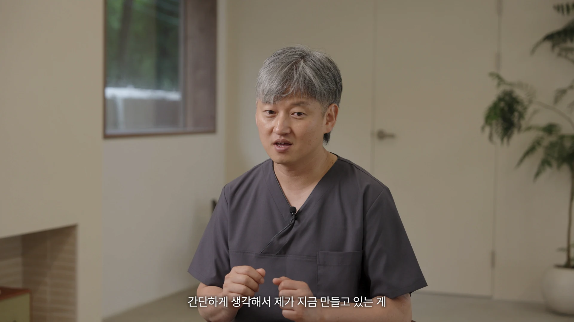 Kim Byeonghee seated, gesturing as he talks about his approach to making restorations