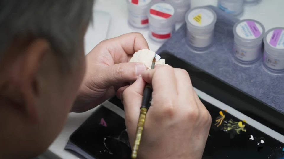 The laboratory manager’s hands checking a piece with a small tool